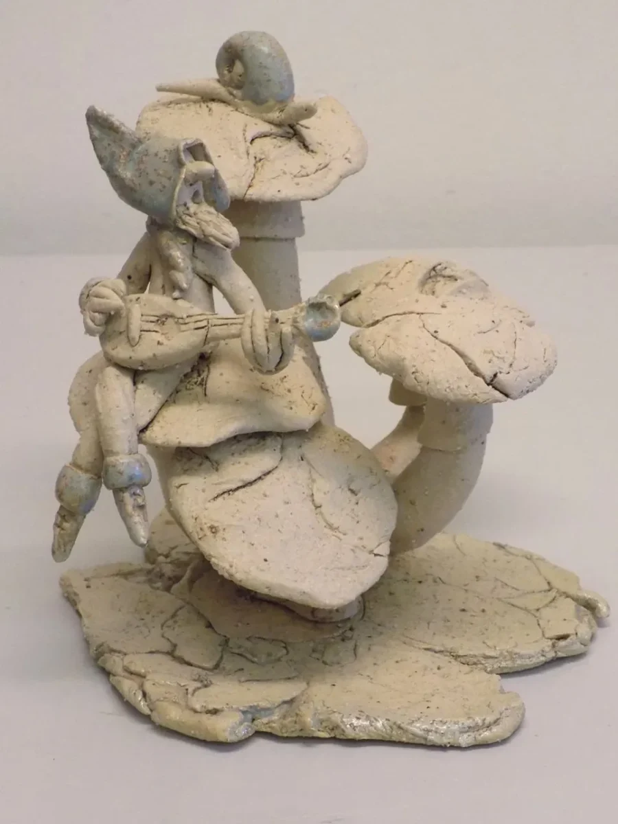 Original Stoneware sculpture of medieval minstrel character seated on toadstools by renowned artist Stewart Taylor